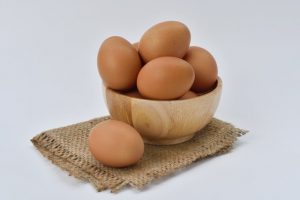 brown-eggs-on-brown-wooden-bowl-on-beige-knit-textile-162712