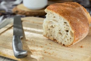 sliced-bread-and-stainless-steel-knife-on-top-of-brown-936190